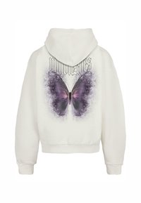 Sudadera corta blanca con un gran gráfico de mariposa púrpura en la parte posterior y el texto "migonzaes" encima. Tejido de algodón suave, ajuste relajado.