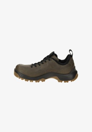 Olive green outdoor shoe with a rugged rubber sole, padded collar, black laces, and contrasting brown outsole, featuring a textured upper.