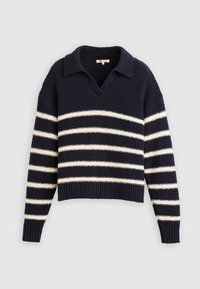 Tmavě modrý pletený svetr s bílými vodorovnými pruhy, výstřihem do V a límečkem. Má žebrované manžety a lem, texturovanou látku.
