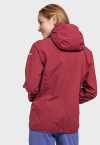 Red lightweight jacket with a hood, made from smooth material. Features elastic cuffs and a slightly tapered design for a fitted look.
