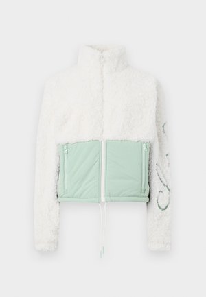 White sherpa fleece jacket with high collar, light green quilted front pockets, and a zipper closure.