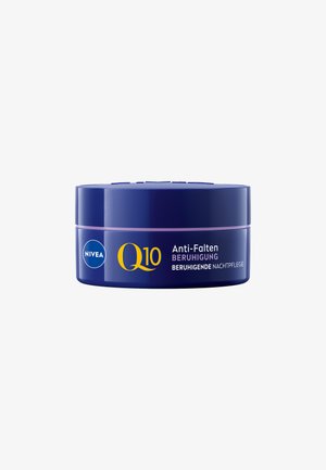 Nivea Q10 night cream in a round, navy blue container. Features a light purple band and yellow text, labeled "Anti-Falten Beruhigung."