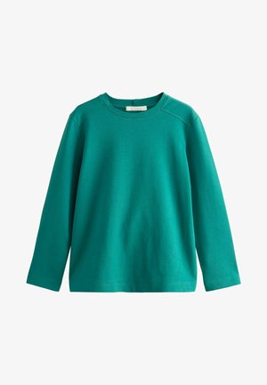 Teal langærmet crewneck skjorte med enkelt design og synlige syninger på skuldrene, lagt fladt på hvid baggrund.