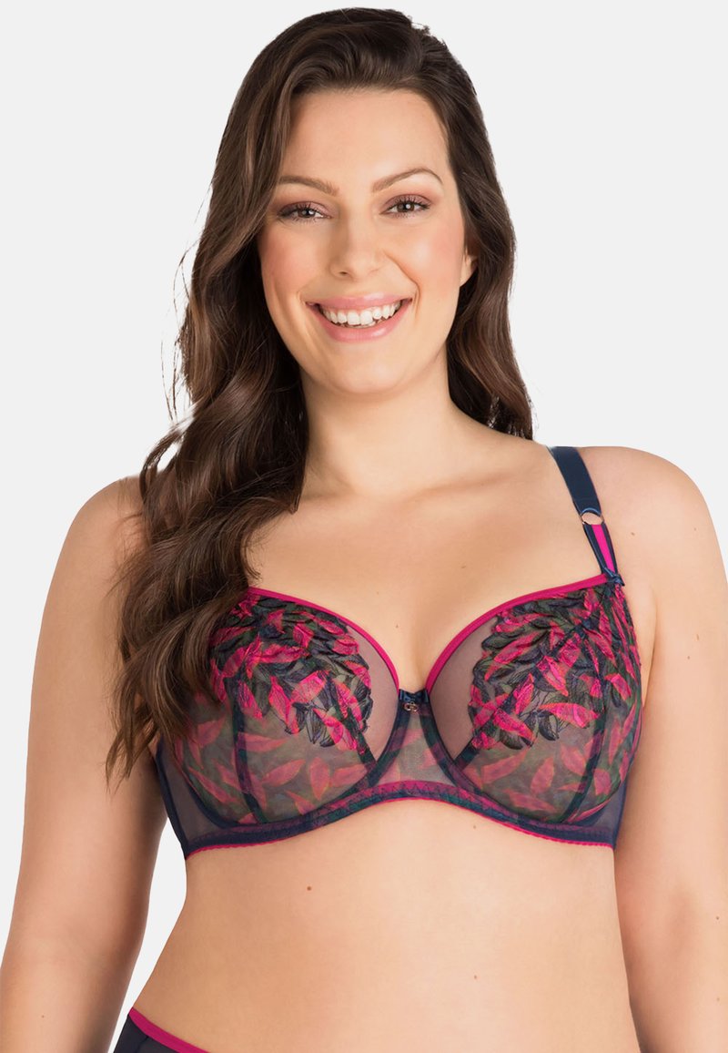 Sujetador con aros de malla transparente en azul marino, bordado de hojas en fucsia y ribete contrastante. Las correas ajustables cuentan con herrajes decorativos.
