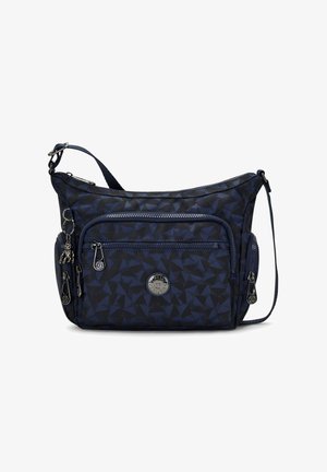 Sac bandoulière bleu et noir à motifs avec plusieurs poches zippées et une sangle d'épaule réglable, avec un petit porte-clés singe.