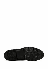 Semelle de chaussure en caoutchouc noir avec un motif de bande de roulement texturé, présentant un talon plat et un motif moulé pour l'adhérence. Surface lisse avec bords arrondis.