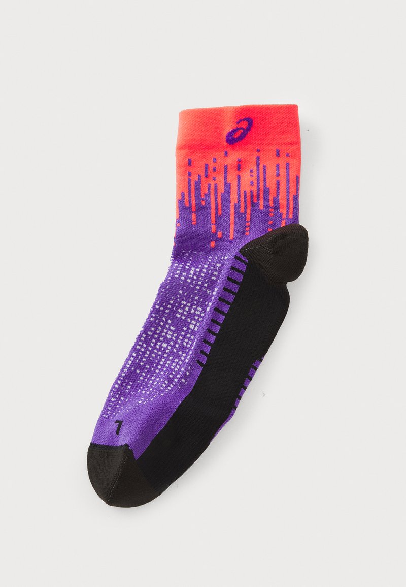 Purple and black athletic sock with gradient orange cuff, dotted pattern, and textured grip on sole; features reinforced toe and heel.