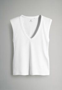 Top sin mangas blanco acanalado con escote en V profundo y dobladillo recto, hecho de tela elástica para comodidad y ajuste.