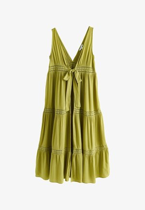 Sleeveless olive green dress with deep V-neck, tiered skirt, lace inserts, and a front tie bow at the waist.