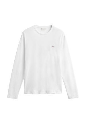 Hvit langermet genser med rund hals og lite brodert skjoldlogo på venstre bryst, enkel design, henger flatt mot hvit bakgrunn.