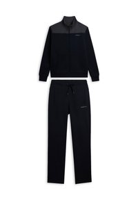 Chándal deportivo azul marino con chaqueta de cremallera que presenta un panel gris y bolsillos, combinado con pantalones a juego con cordón. Textura suave.