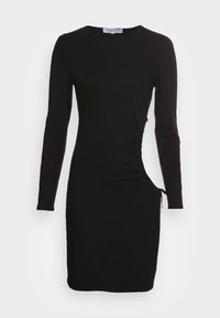 Veste preta de mangas longas feita de um tecido suave e elástico. Apresenta franzidos laterais e cordão ajustável na bainha para comprimentos variados.
