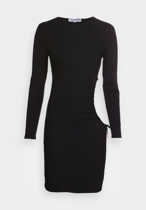 Veste preta de mangas longas feita de um tecido suave e elástico. Apresenta franzidos laterais e cordão ajustável na bainha para comprimentos variados.
