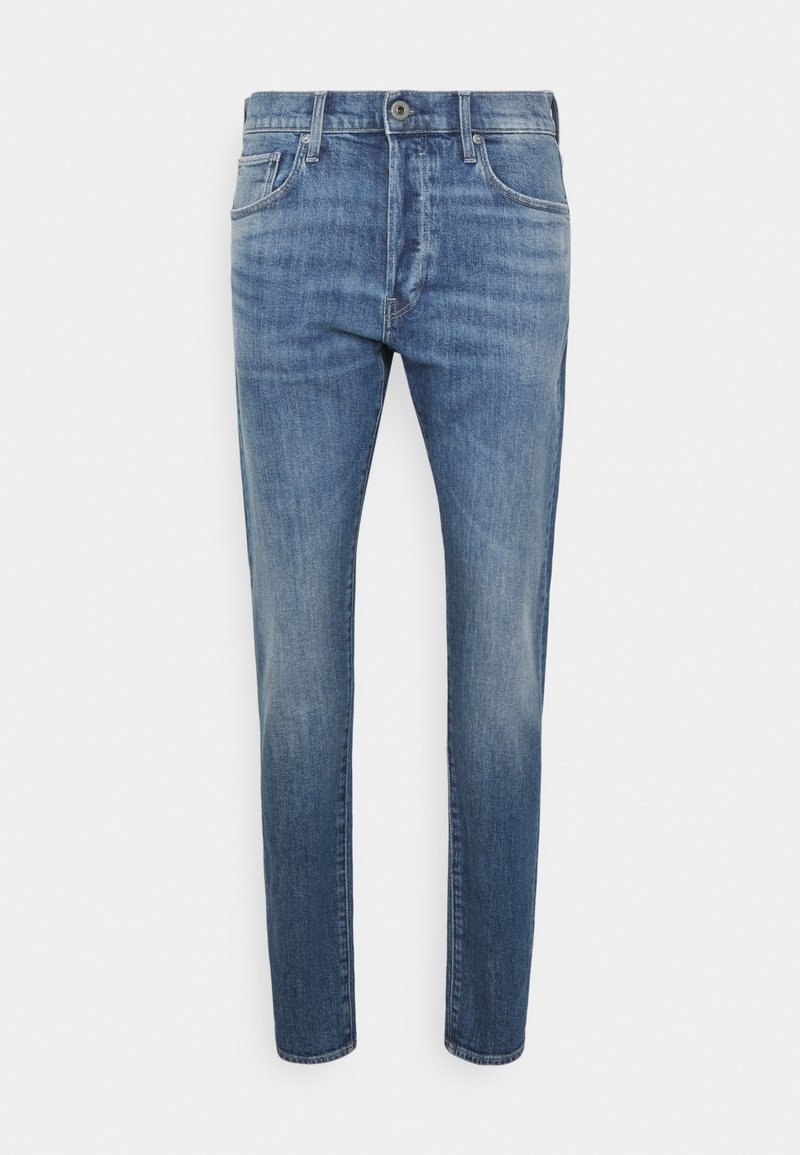 Ljusblå denimjeans har en slim fit, femfickorsdesign och knäppning med knapp. Tyget har en blekt tvättmönster och jämn textur.