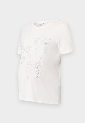 Balta kokvilnas T-krekls ar īsām piedurknēm, kuram ir lapu dizains, izklāts ar maziem metalizētiem studiem. Apaļa kakla izgriezums, brīvs piegriezums.