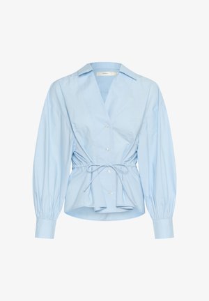 Helehelesin sinine puuvillane särk, millel on sügav V-kaelus, elastne vöökoht ja balloonvarrukad. Esiküljel on viis nuppu.