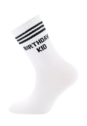 Weißer Kniestrumpf bis zur Mitte der Wade mit schwarzen Streifen oben und dem Schriftzug "BIRTHDAY KID" in Schwarz unterhalb der Streifen gestrickt.