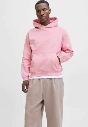 Pink hoodie with a front pocket and embroidered logo, paired with light brown wide-leg pants. Smooth fabric and relaxed fit.