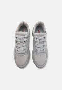 Gray athletic shoes with mesh fabric upper, flat laces, cushioned sole, and HTS logo on the tongue; features rounded toe and breathable design.