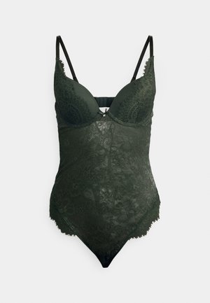 Bodysuit en dentelle vert foncé avec des bonnets moulés, des bretelles ajustables et des motifs floraux complexes. Texture douce et bords festonnés.