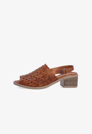 Brown leather slingback sandal with cut-out pattern, block heel, adjustable buckle strap, and open toe design.