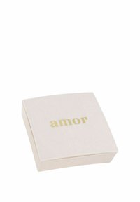 Scatola quadrata di colore rosa pallido con angoli arrotondati e superficie liscia, con lettering dorato che dice "amor" sulla parte superiore.