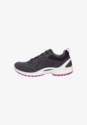 Black athletic shoe with a textured upper, mesh panels, and purple accents on the outsole. Features laces and a pull tab at the heel.