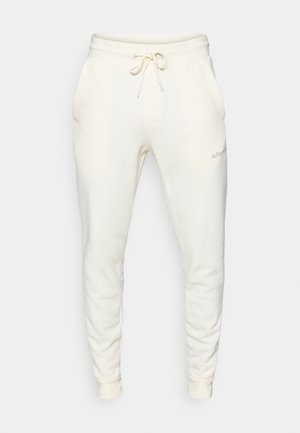 Weiße Sweatpants aus weichem Material, mit einem elastischen Bund und Kordelzug, Seitentaschen und gerippten Bündchen.