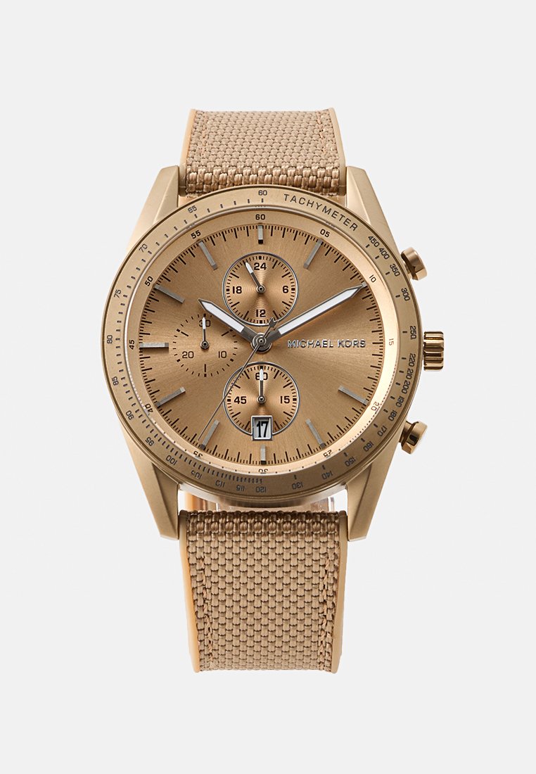 Montre chronographe en tonalité or avec un bracelet en tissu beige, un cadran texturé, des sous-cadrans et un affichage de la date à la position 6 heures.