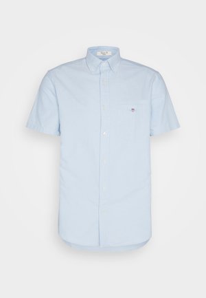 Light blue short-sleeved button-up shirt made of cotton fabric, featuring a pocket on the left with a small logo and a standard collar.