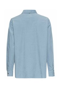 Chemise en velours côtelé bleu clair à manches longues vue de dos, avec col classique et poignets boutonnés.