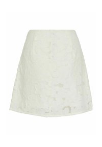 Jupe blanche trapèze avec superposition de dentelle florale et motif texturé subtil, longueur genou et taille haute.