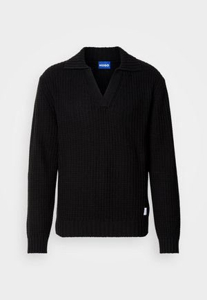 Black knitted sweater featuring a V-neck and ribbed texture, with a folded collar and a small logo tag on the lower side.