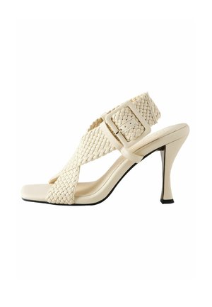 Beige woven high-heeled sandal with a square toe, wide straps, a large buckle, and a sleek heel design, featuring a black accent sole.