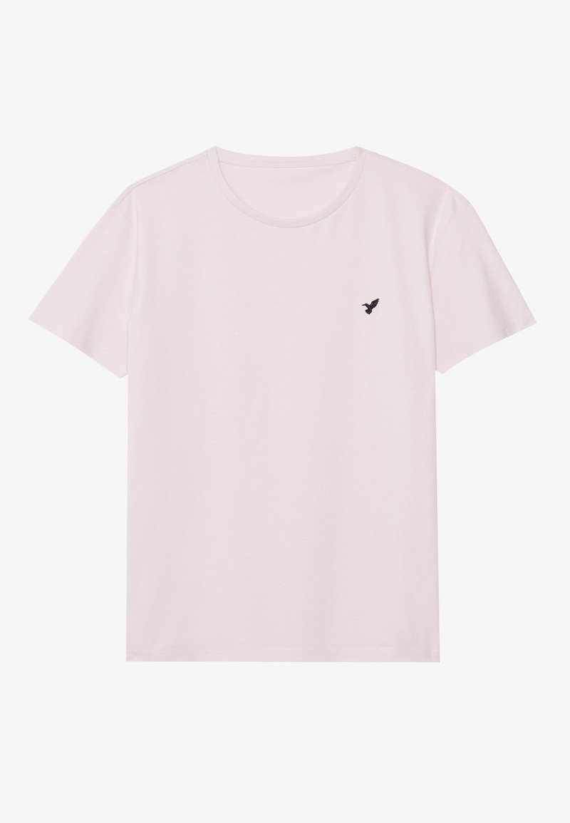 T-shirt rose clair à manches courtes et col rond avec un petit logo d'oiseau noir sur le côté gauche de la poitrine.