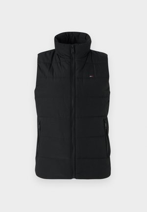 Chaleco acolchado negro con cuello alto, cierre frontal y dos bolsillos laterales con cremallera. Tejido suave con textura acolchada y detalle del logo.