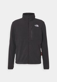 Czarna polarowa kurtka z pełnym zamkiem i wysokim kołnierzem, kieszonką na zamek na klatce piersiowej, bocznymi kieszeniami oraz białym logo The North Face na lewej piersi.
