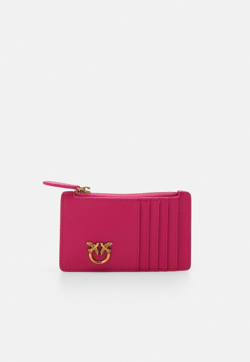 Pink leather wallet with gold hardware, featuring card slots, a zippered compartment, and embossed detailing on the front.
