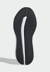 Suela de zapato de goma negra con patrones de agarre texturizados. Presenta un acento blanco a lo largo del costado. Diseño curvado con un tacón cónico.