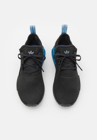 Ténis desportivos pretos com detalhes em azul, parte superior em malha texturizada, bico redondo, atacadores planos e lingueta almofadada com o logótipo da marca na lateral e no calcanhar.