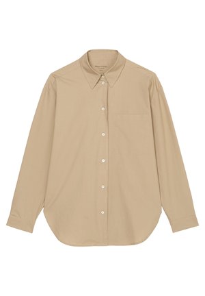 Chemise beige à manches longues boutonnée avec poche devant et col pointu, posée à plat sur fond blanc.