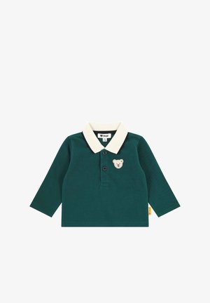 Green long-sleeve polo shirt with a cream collar, three buttons, and a bear patch on the chest. Features soft fabric texture.