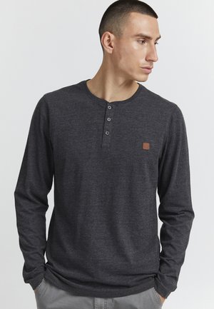Dark gray long-sleeve henley shirt made of soft fabric, featuring a three-button placket and a small brown logo patch on the chest.