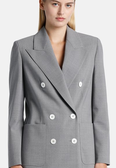 Gray double-breasted blazer made of textured fabric, featuring white buttons, large lapels, and two front pockets.