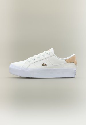 White low-top sneaker with beige heel tab, white laces, thick sole, and small embroidered crocodile logo on the side.