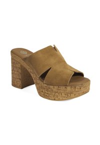 Suede platform mules in tan met een brede uitsnijding. Dikke, gestructureerde kurken hak en basis zorgen voor extra hoogte en stabiliteit.