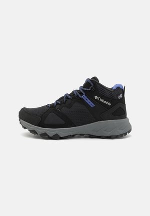 Black hiking shoe with mesh and suede upper, gray rubber sole, blue laces, and Columbia logo on the heel. Textured accents enhance grip.