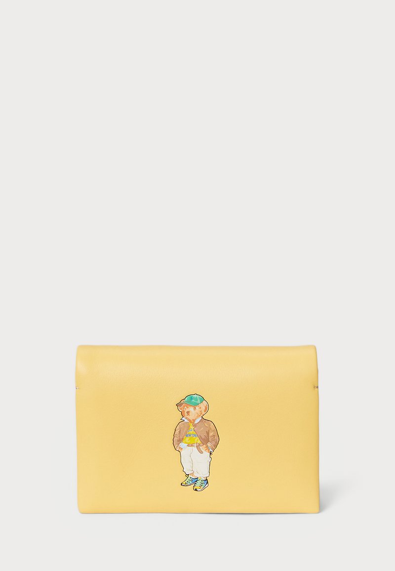 Yellow leather clutch with a smooth texture. Features a colorful graphic of a bear in casual clothing on the front. Fold-over design.