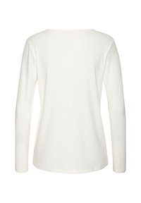 Langärmliges weißes Oberteil aus geripptem Stoff. Mit einem runden Ausschnitt und einer taillierten Silhouette. Glatte Textur mit einem schlichten Rücken.