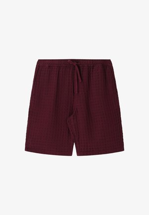 Shorts en tissu texturé bordeaux avec taille élastique, cordon de serrage à l'avant et poches latérales, conçus pour un usage décontracté.